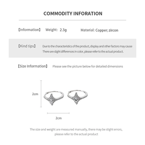Macro detail of silver star-shaped earrings with zircon inlay showing 2cm size measurement
