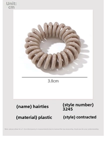 Detail view of a 3.8cm light brown spiral phone cord hair tie with product dimensions