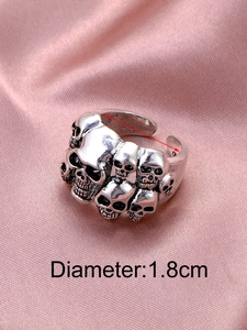 Macro shot of silver gothic skull ring on pink satin showing 1.8cm inner diameter detail