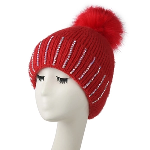Red winter knit beanie with faux fur pom-pom and sparkling rhinestone stripes for women