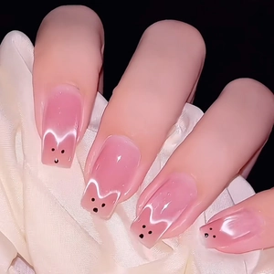 Pink cartoon cat-themed fake nails with white ears and black facial details on silk