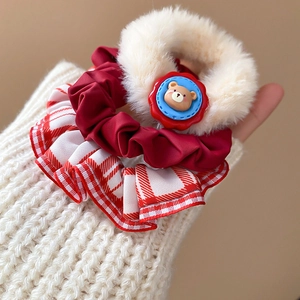 Detail of plush polka dot scrunchie with cute bear doll and soft fabric texture