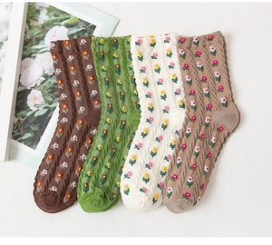 Close-up of four-pack ribbed cotton socks with floral tulip embroidery in autumn colors