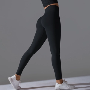Detail of high waisted compression yoga leggings showing black peach lift design