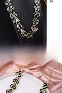 Detail of vintage black enamel necklace with gold interlocking rings and adjustable lobster clasp