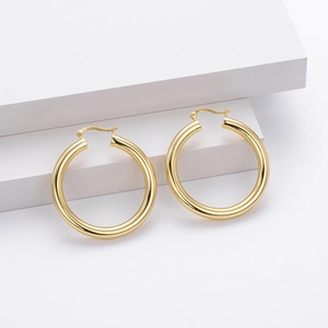 Polished S925 sterling silver gold plated large hoop earrings on minimalist background