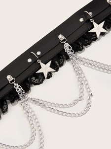 Detail of punk belt with lace, silver star pendants, metal rivets and layered chains