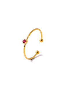 Detail view of gold stainless steel ring featuring a bezel-set purple zircon stone