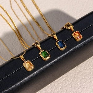 Detail of Figaro necklaces with champagne, emerald, blue, and amber zircon pendants