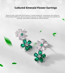 Close-up of flower shaped earrings with lab-grown emeralds and white zircons