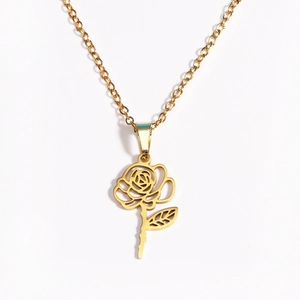 Macro detail of 18k gold plated stainless steel rose flower pendant necklace