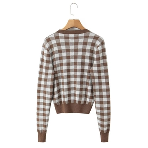 Detailed back view of the brown and white checkered knit cardigan on a wooden hanger