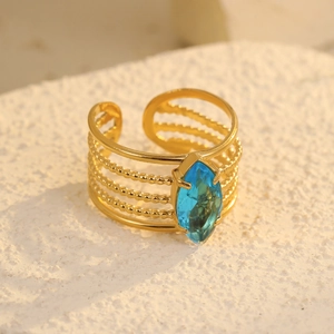 Gold-tone hollow wide ring with marquise blue zircon and multi-strand textured band