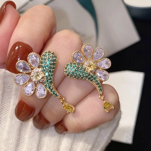 Elegant gold flower tassel earrings with purple and yellow crystals for a chic look
