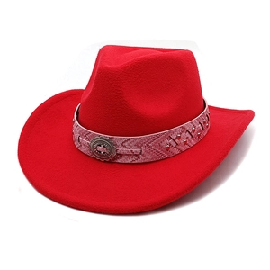 Close-up of red felt cowboy hat with metallic logo band and western rivet detailing
