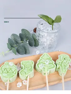 Christmas silicone ice cream molds in tree and stocking shapes on a wooden tray