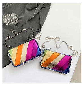 Detail of metallic rainbow striped crossbody bags with silver bead chains and beaded trim
