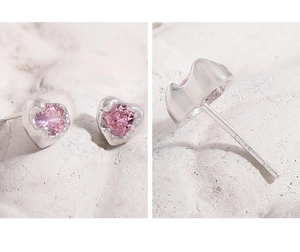 Close-up of S925 sterling silver pink heart stud earrings showing hallmarked posts