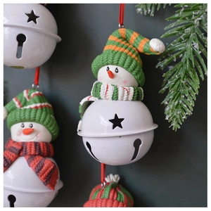 Detailed view of handmade snowman Christmas bells with knitted hats and star cutout patterns
