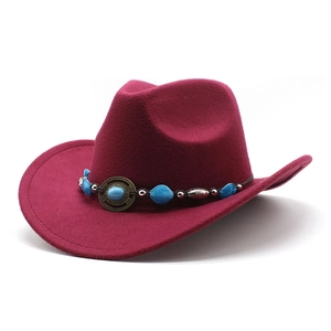 Detail of burgundy wool felt cowboy hat with ethnic beads and turquoise metal buckle