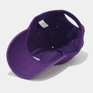Detailed interior of purple cotton baseball cap with sweatband and adjustable buckle