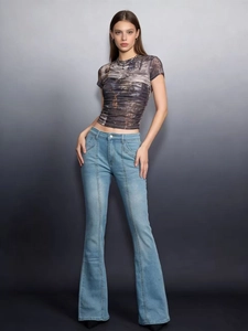 Detail of light blue washed flare jeans with distinct middle seam stitching for women