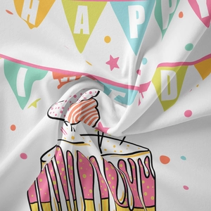 Detail view of soft fabric tapestry with colorful cake print and Happy Birthday banner