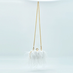 Detail of white ostrich feather evening bag with gold chain and ring-shaped clasp