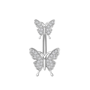 Close-up of silver navel piercing featuring two butterfly motifs set with zircon stones