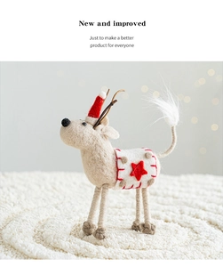 Detailed view of handmade wool felt Christmas reindeer with red star embroidery and mini hat