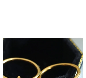 Close-up of gold-plated rings presented in a black velvet jewelry box for display