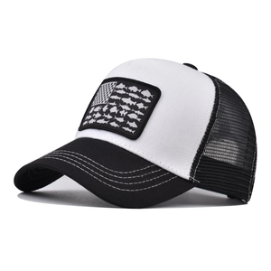 Detail view of truck hat featuring fish silhouette US flag patch on breathable mesh