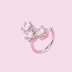 Detail macro view of silver ear cuff with three sparkling round cubic zirconia stones