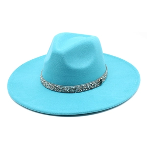 Detail of teal wool fedora hat with silver rhinestone band and metal M logo accent