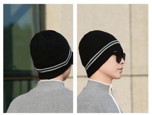Detail showing the gray double stripe pattern on a black knitted winter beanie hat
