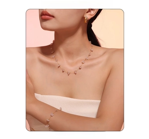 Detail of bohemian gold jewelry set featuring pink natural stone on necklace and earrings