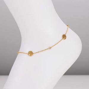 Gold stainless steel tree of life anklet with sparkling zircon stones on a foot model
