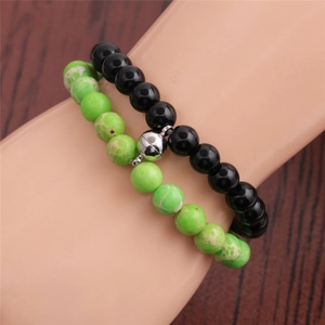 Close-up of 8mm beaded magnetic couple bracelets worn on wrist with stone textures