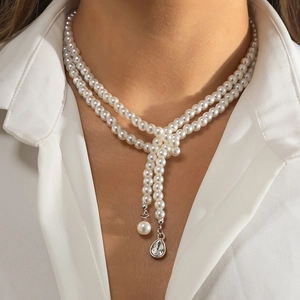 Double-layered pearl necklace with Y-shaped droplet rhinestone pendant on a model