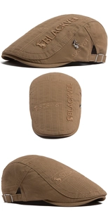 Detail view of cotton flat cap with 3D embroidery and silver rabbit emblem on brown fabric