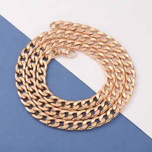 Close-up of golden stainless steel Cuban link chain necklace with a lobster clasp