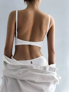 Macro detail of seamless white ice silk bra back closure and thin adjustable straps