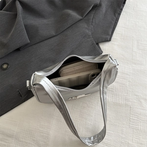 Silver crescent underarm bag showing spacious interior with smartphone and wallet storage