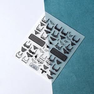 Detail macro of 5D embossed lace underwear nail art stickers with black heart and wings