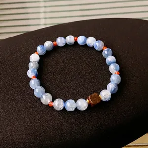 Blue marble textured beads bracelet with a brown square sandalwood bead and gold spacers