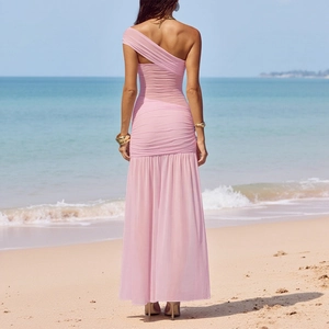 Detail of pink one-shoulder pleated dress with side slit back view on beach setting