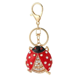 Detailed view of beetle keychain with red enamel and sparkling rhinestones on gold alloy