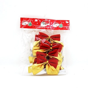 Detail of red and gold Christmas tree bows set in simple card-head plastic packaging