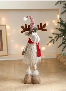 Detail of Christmas reindeer doll with knitted hat, snowflake button and plush texture