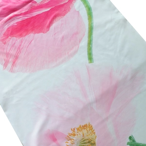 Detailed view of pink floral print and fabric texture on a summer A-line maxi dress